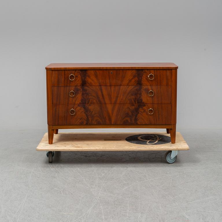 A 1940s Swedish Modern mahogany veneered chest of three drawers.