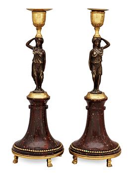 629. A pair of late Gustavian circa 1800 porphyry and bronze candlesticks.
