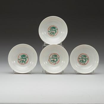 A set of four yellow ground famille rose bowls with covers, early 20th century with Guangxu six character mark in red.