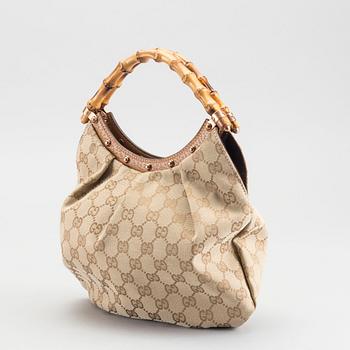 A GUCCI BAG, "STUDDED  BAMBOO HANDLE".