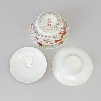 A Chinese 20th century famille rose porcelain cup with cover and dish, with Guangxus six character mark.