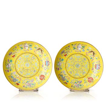 1004. A pair of yellow ground famille rose dishes, Qing dynasty, with Guangxu mark and period, circa 1900.