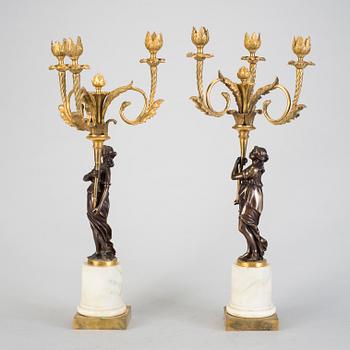 A pair of 19h Century Louis XVI style three-light candelabra in bronze and marble.