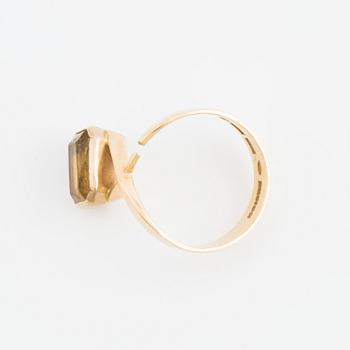 A ring set with an octagonal, step-cut citrine.