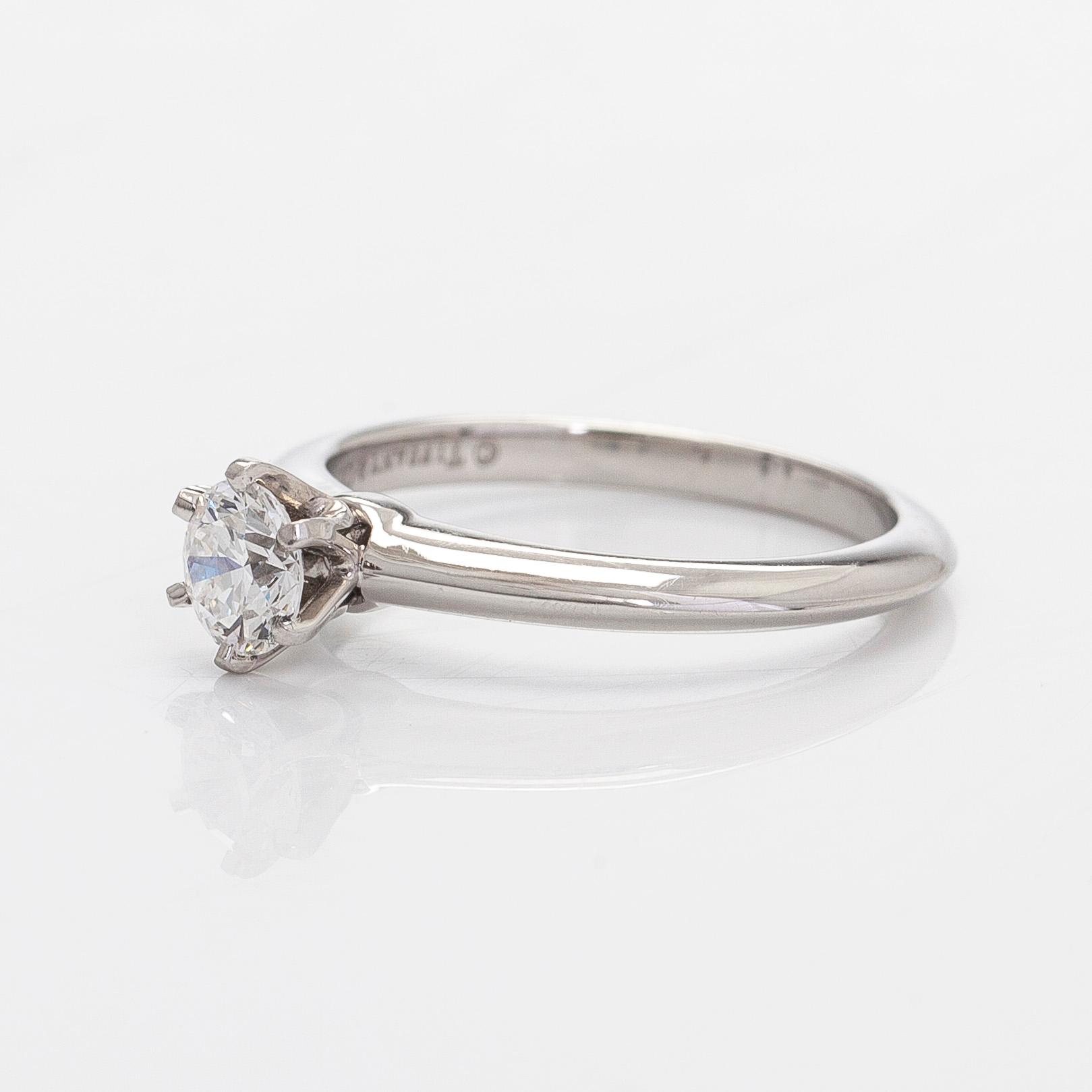 Tiffany & Co, a platinum solitaire ring with a brilliant-cut diamond.