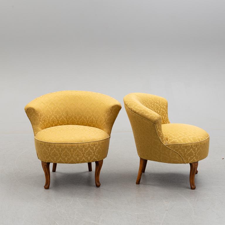 An early 20th century pair of rococo style easy chairs.