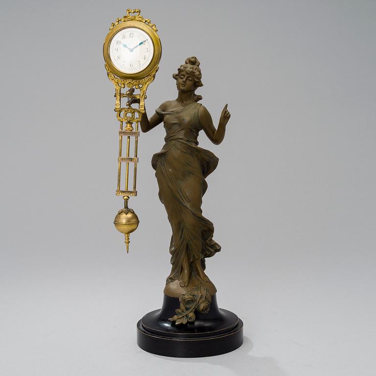 A 1930s Junghans swinger clock with girl sculpture.