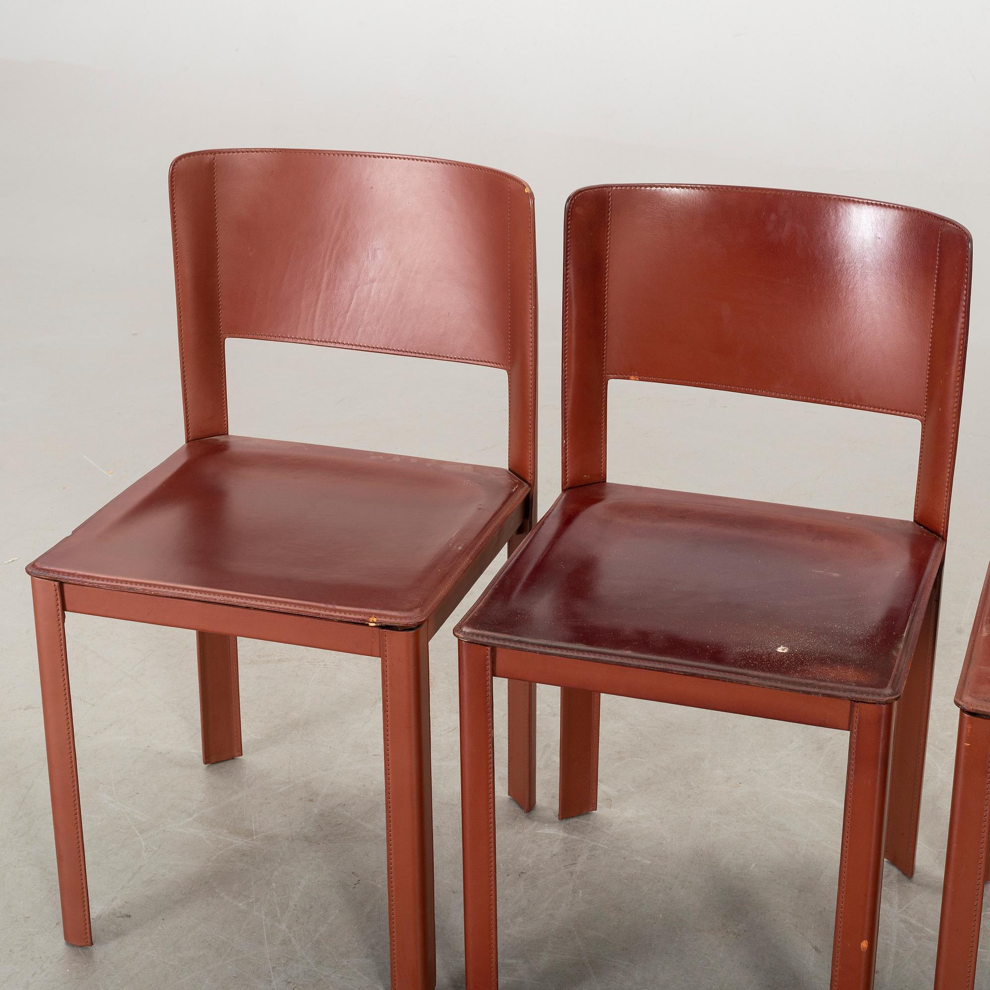 MATTEO GRASSI, a set of four leather chairs.