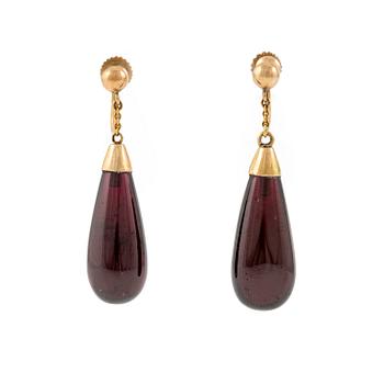 524A. A pair of 14K gold earrings with garnet drops.