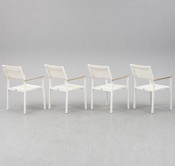 A garden table with four chairs, Gloster.