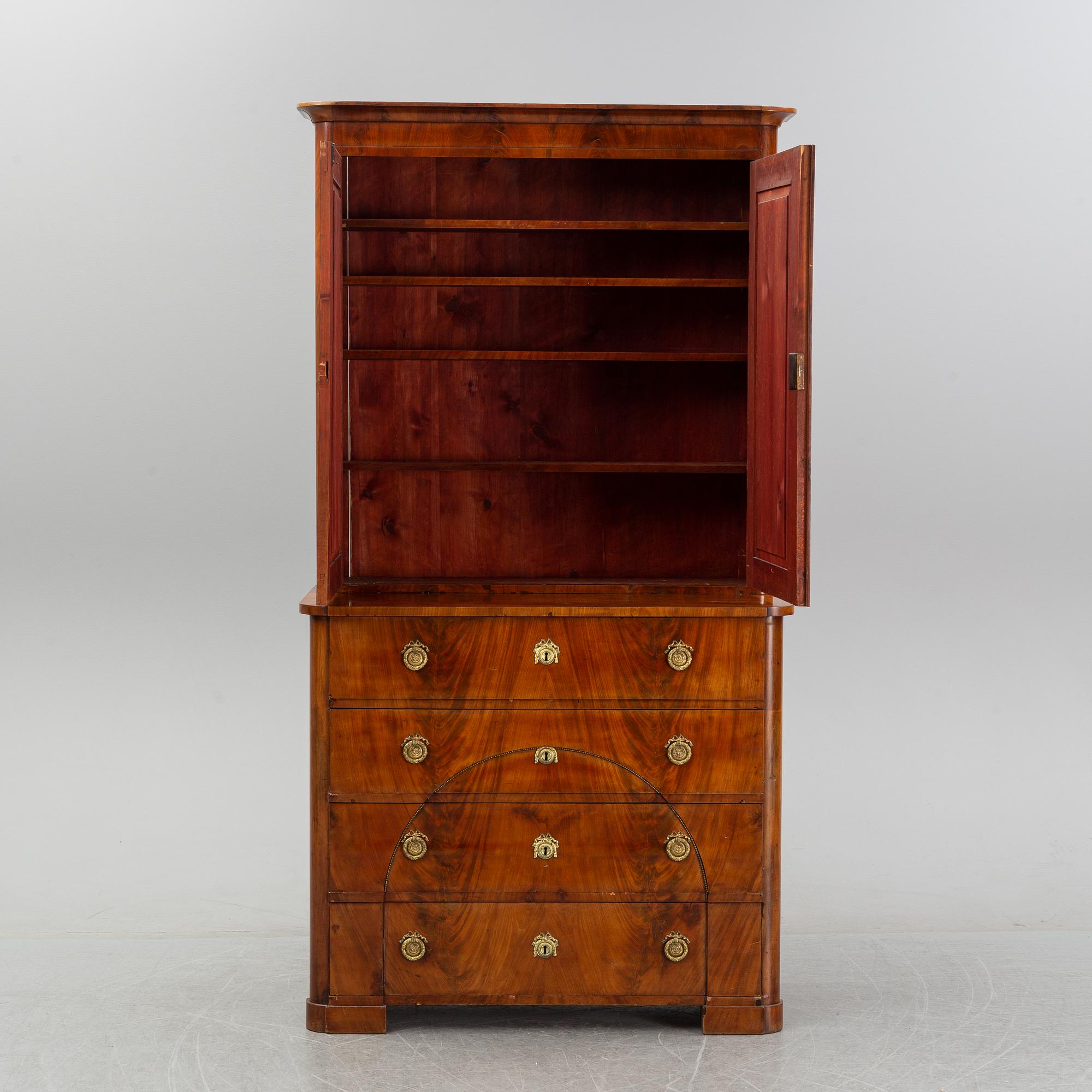 A mahogany veneered Empire cupboard, first half of the 19th century.