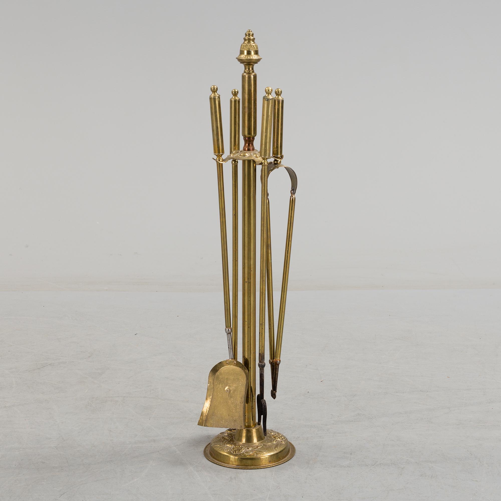 A set of 4 brass fire utensils with stand, 20th Century.