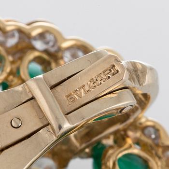 A pair of Bulgari earrings set with cabochon-cut emeralds and round brilliant-cut diamonds.
