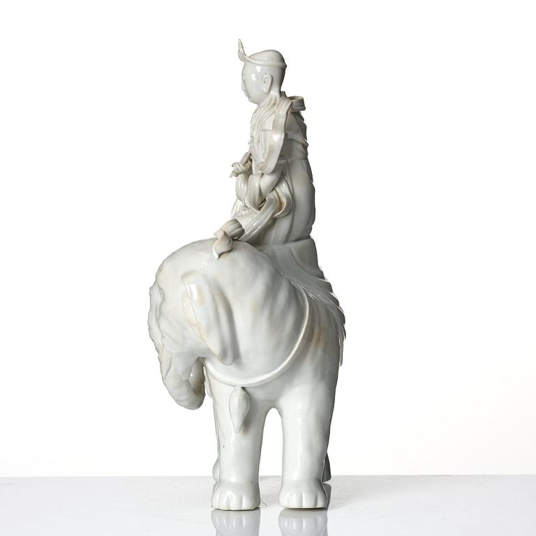 A large blanc-de-chine figure of Guanyin riding an elephant, late Qing dynasty/early 20th Century.