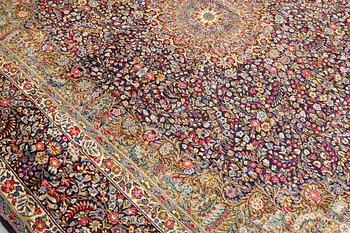 A Kirman Laver carpet, approx. 424 x 305 cm.