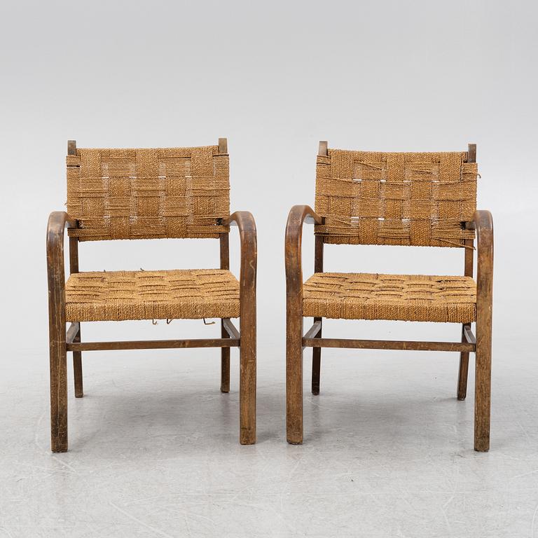 A pair of stained beech armchairs, first half of the 20th Century.