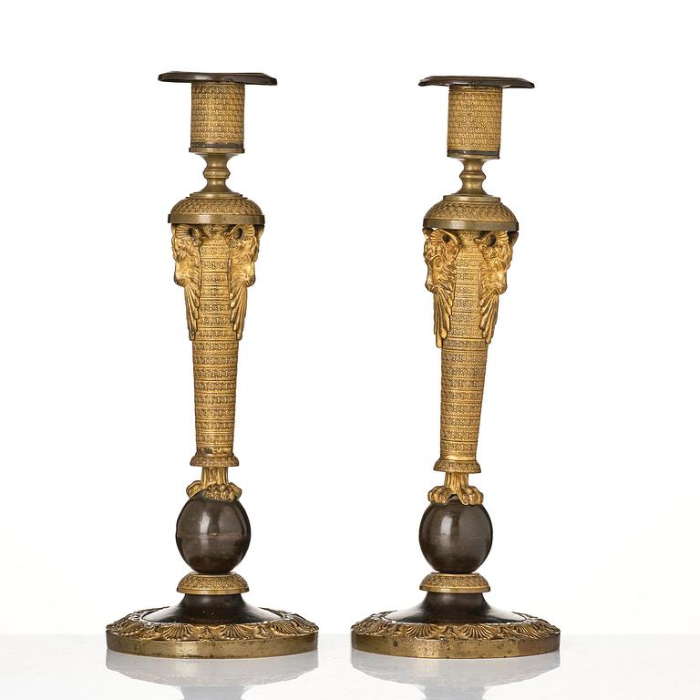 A pair of Russian Empire ormolu and patinated bronze candlesticks, Moscow circa 1800.