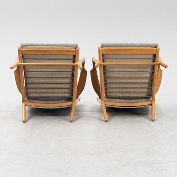 Hans J Wegner, a pair of model AP-16 armchairs, Denmark mid 20th century.