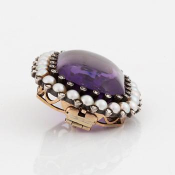 A silver and gold brooch/pendant set with an amethyst and pearls and rose-cut diamonds.