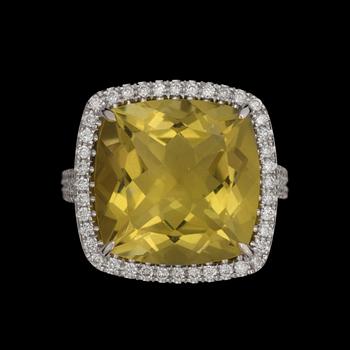 A greenish-yellow quartz ring, 14 cts, set with brilliant cut diamonds, tot. 0.64 ct.