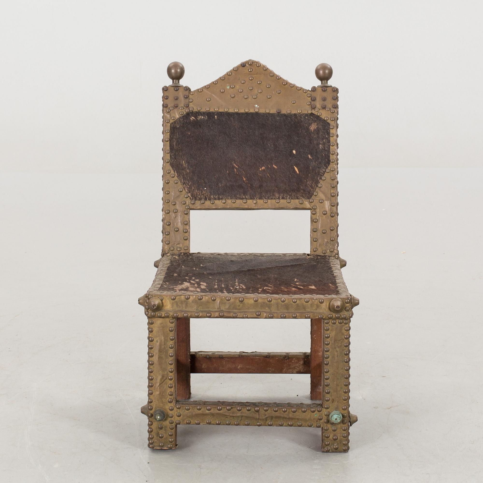 An Ashanti chair, Ghana, hardwood with brass studs, ca 1900.