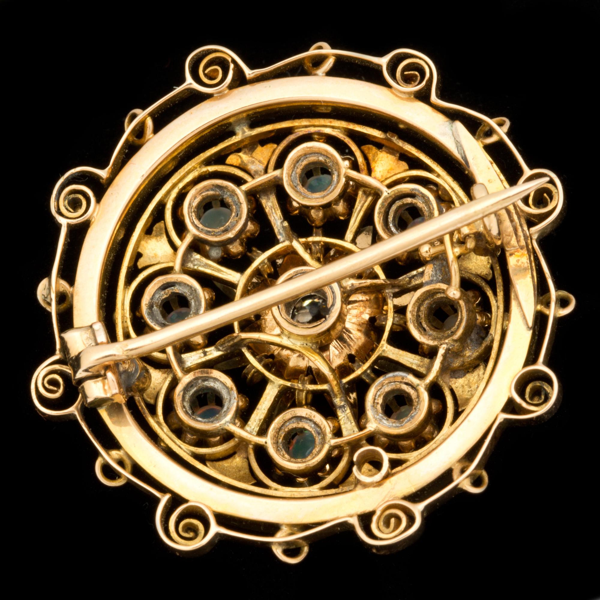 A 0.20 ct old-cut diamond and opal brooch.