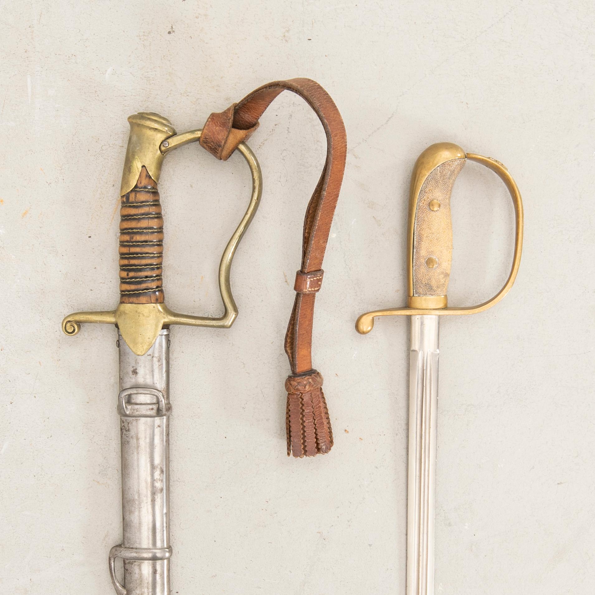 A Swedish sabre 1899 pattern with scabbard with another sword.