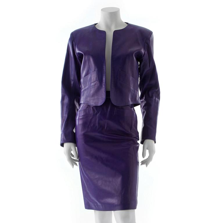 YVES SAINT LAURENT, a purple leather two-piece dress consisting of jacket and skirt.