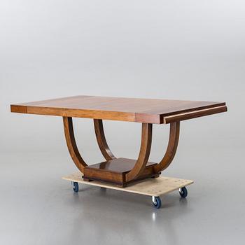 A french art deco dining table with extra boards.