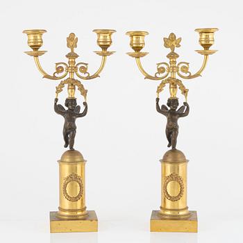 A pair of North European ormolu and patinated bronze two-light candelabra, earlt 19th century.