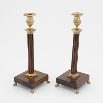 A pair of late Gustavian mahogany and brass candlesticks, circa 1800.