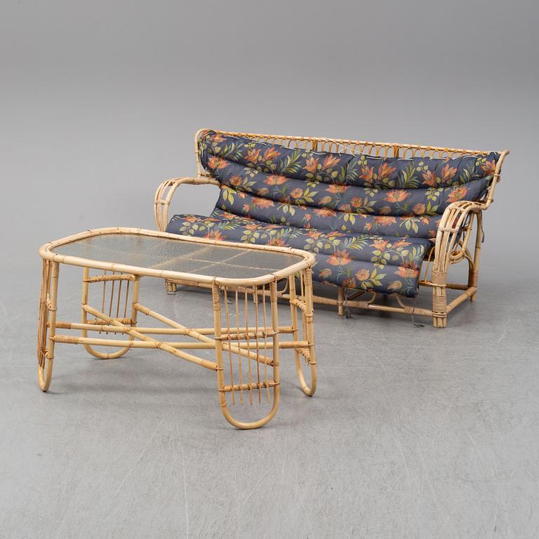 A rattan and glass table and a rattan sofa, second half of the 20th century.