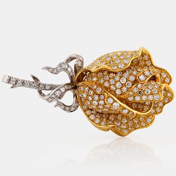 An 18K gold and platinum brooch in the shape of a rose set with eight-cut diamonds.