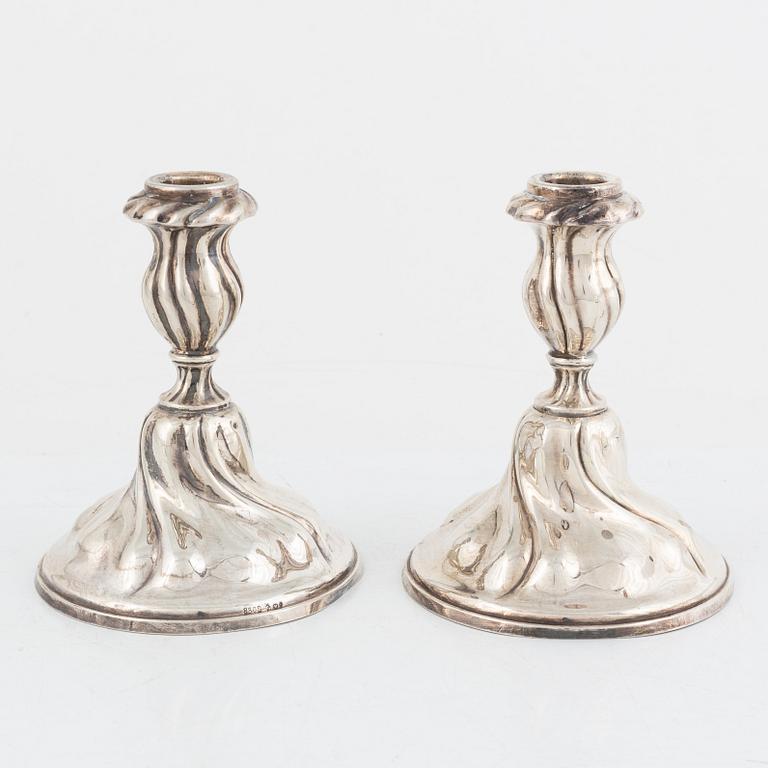 A pair of silver rococ-style candle sticks, presumably Germany, 20th century.