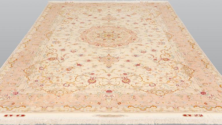 A Tabriz part silk carpet, signed, 305 x 203 cm.