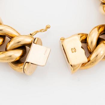 An 18K gold bracelet.