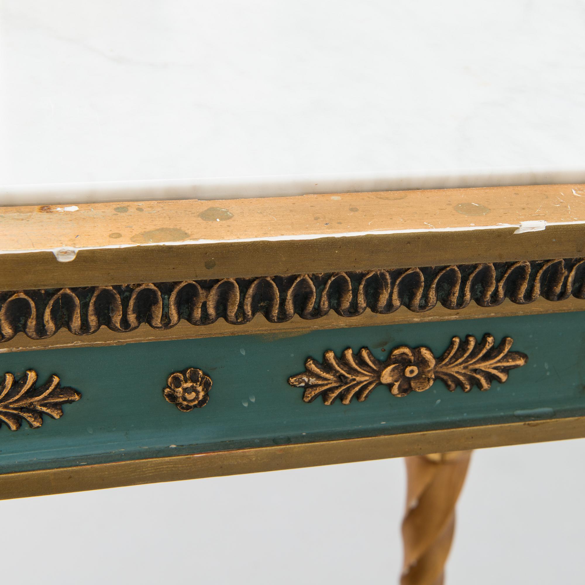 An early 20th century mirror with console table in late Gustavian style.