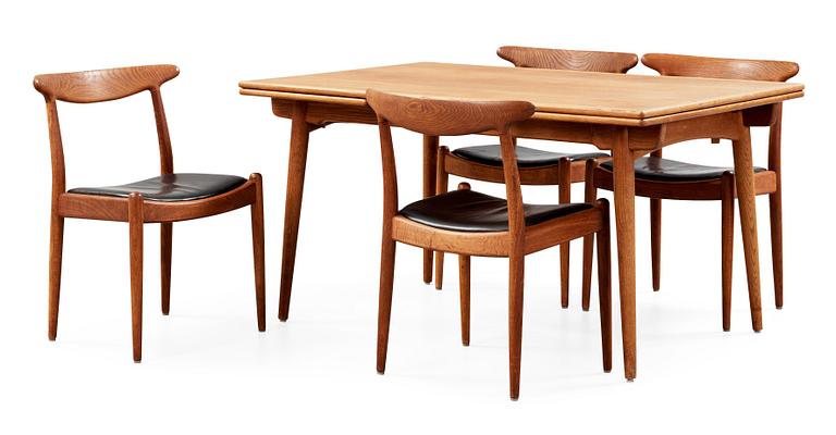 A Hans J Wegner oak dinner table 'AT 312' and four oak and black leather chairs, C M Madsen, Denmark 1950-60's.