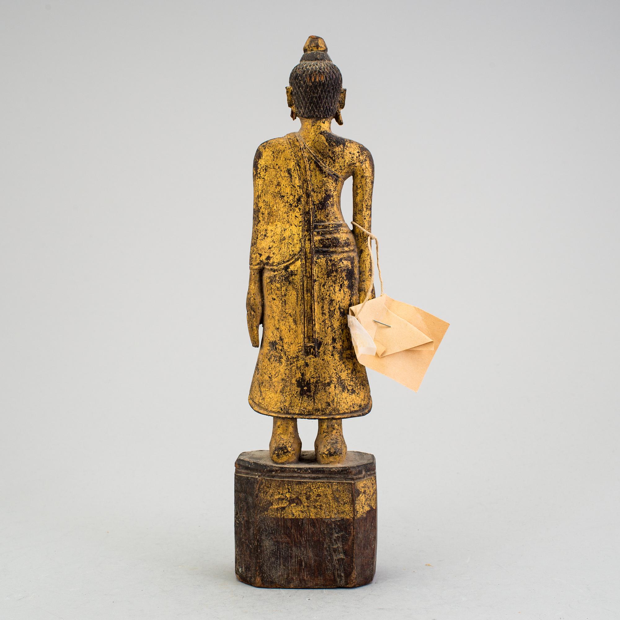 A Burmese sculpture of a standing buddha, circa 1900.