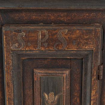 A painted corner cabinet, dated 1800.