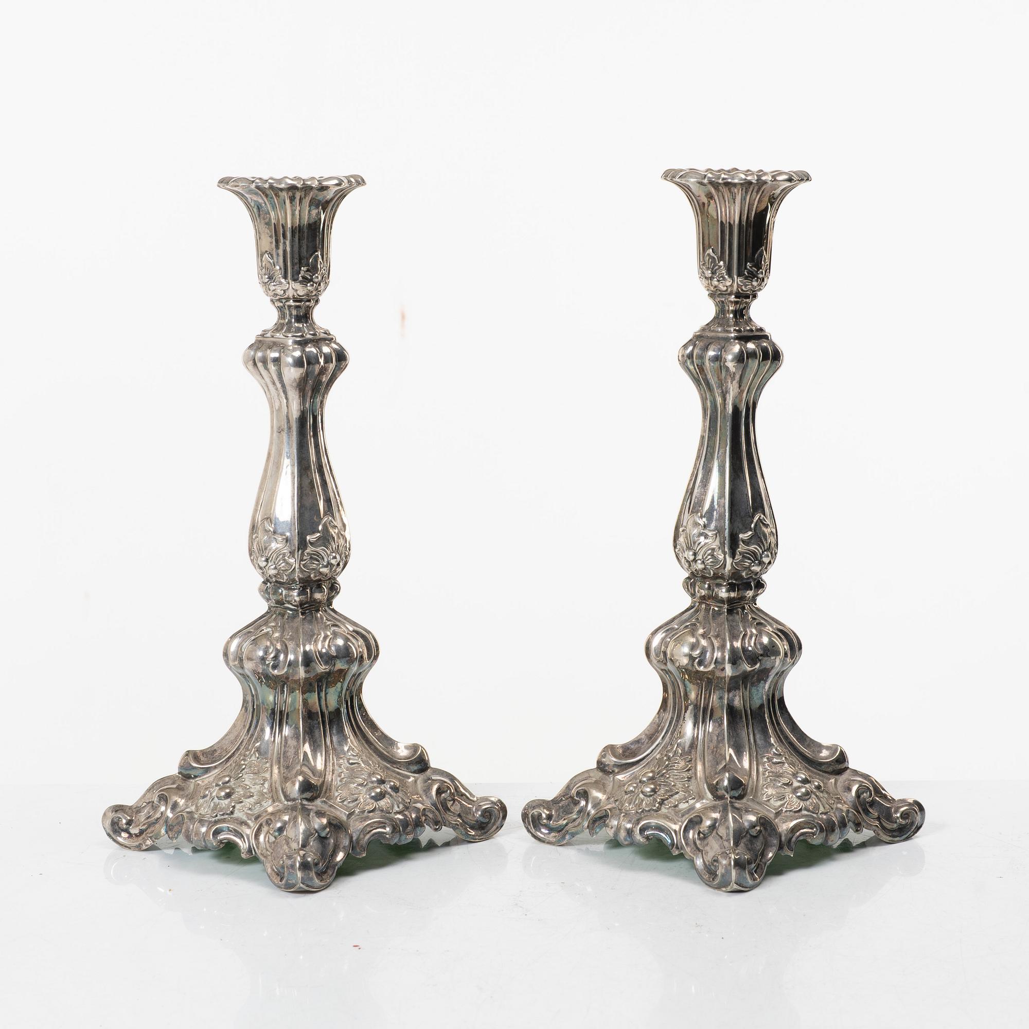A pair of rococo-style silver candle sticks, early 20th century.