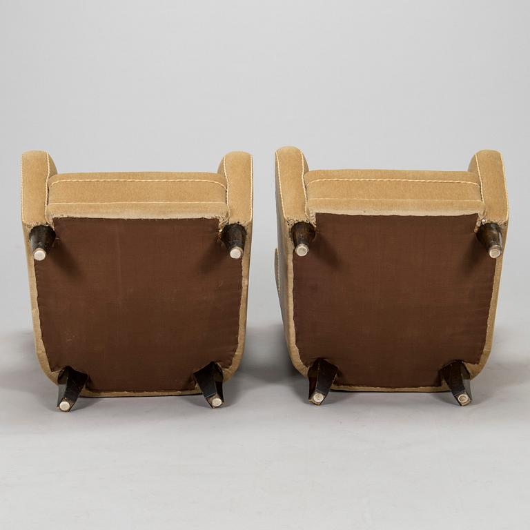 A pair of mid-20th century armchairs.