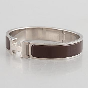 Hermès, a 'Clic H' bracelet.