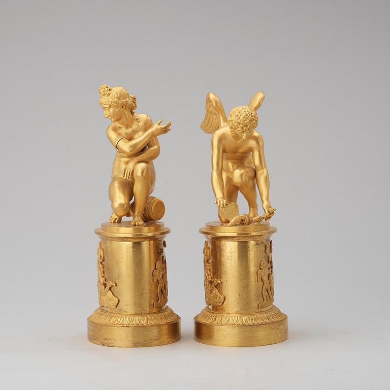 A pair of early 19th century Empire gilt bronze table sculptures.