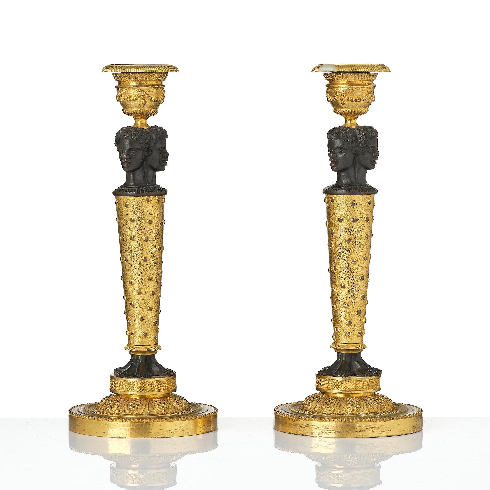 A pair of Napoleon III gilt and patinated bronze candlesticks, later part 19th century.