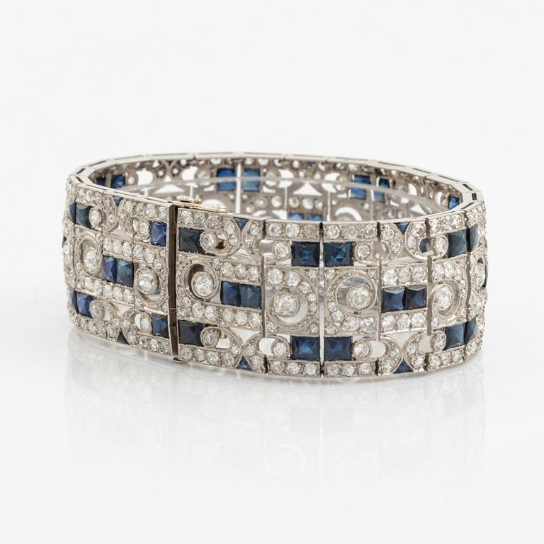 A platinum bracelet set with old-cut diamonds and step-cut sapphires.