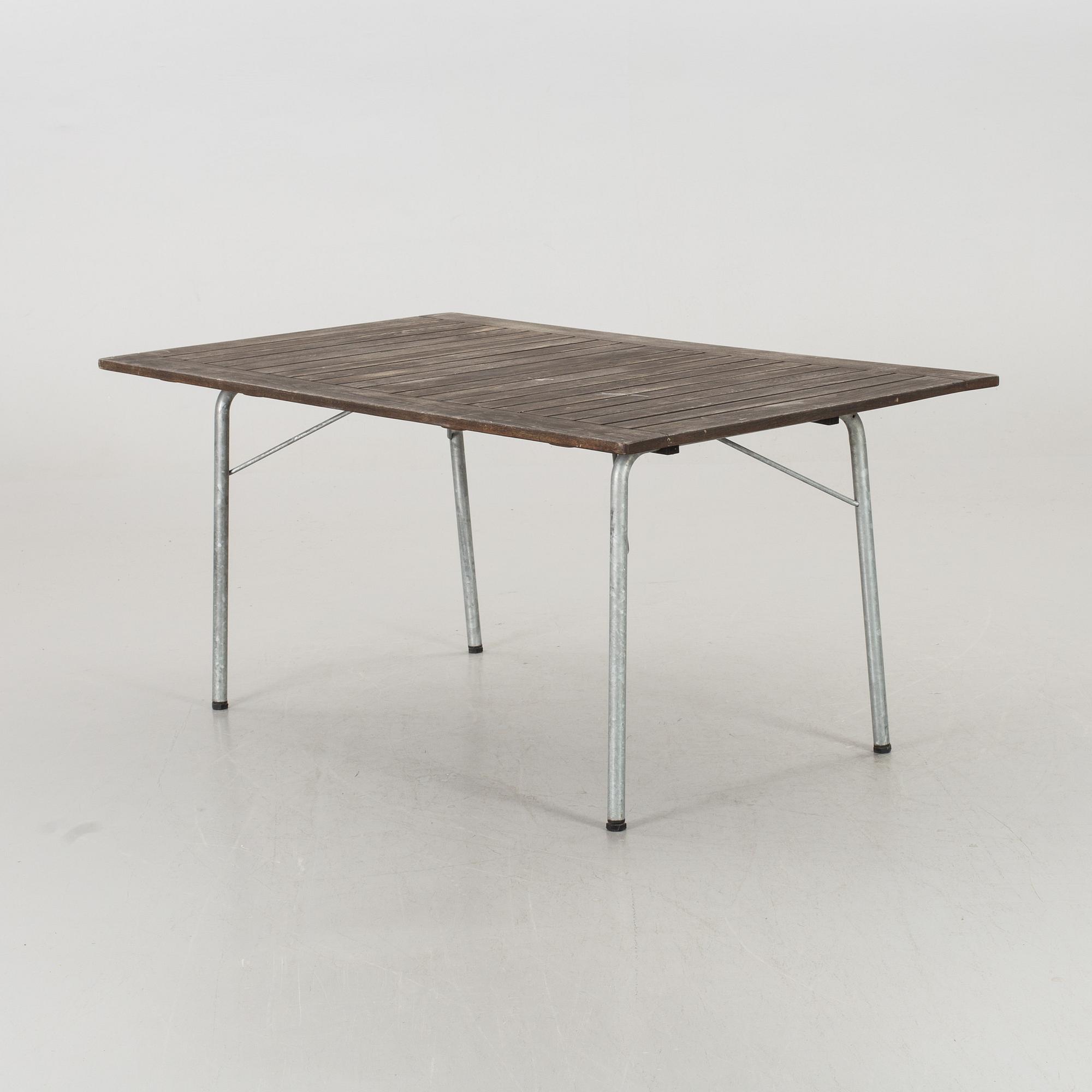 A GARDEN TABLE AND FOUR ARMCHAIRS FORM GRYTHYTTAN.