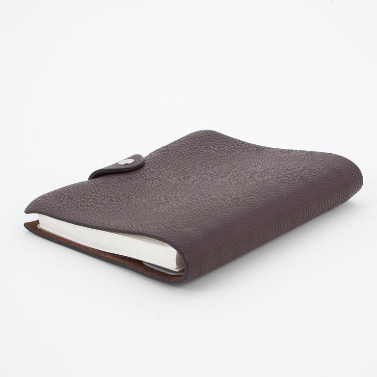 HERMÈS, a brown leather notebook, "Ulysse Petit Modèle".