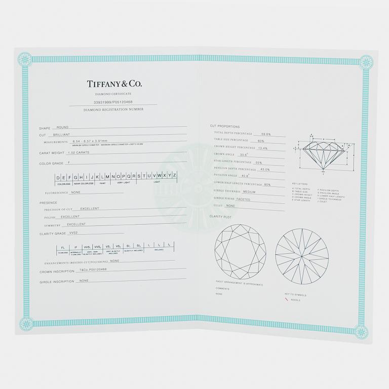 A pair of Tiffany solitaire diamond stud earrings in platinum.