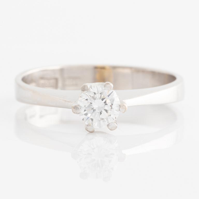 Ring solitaire with brilliant-cut diamond.